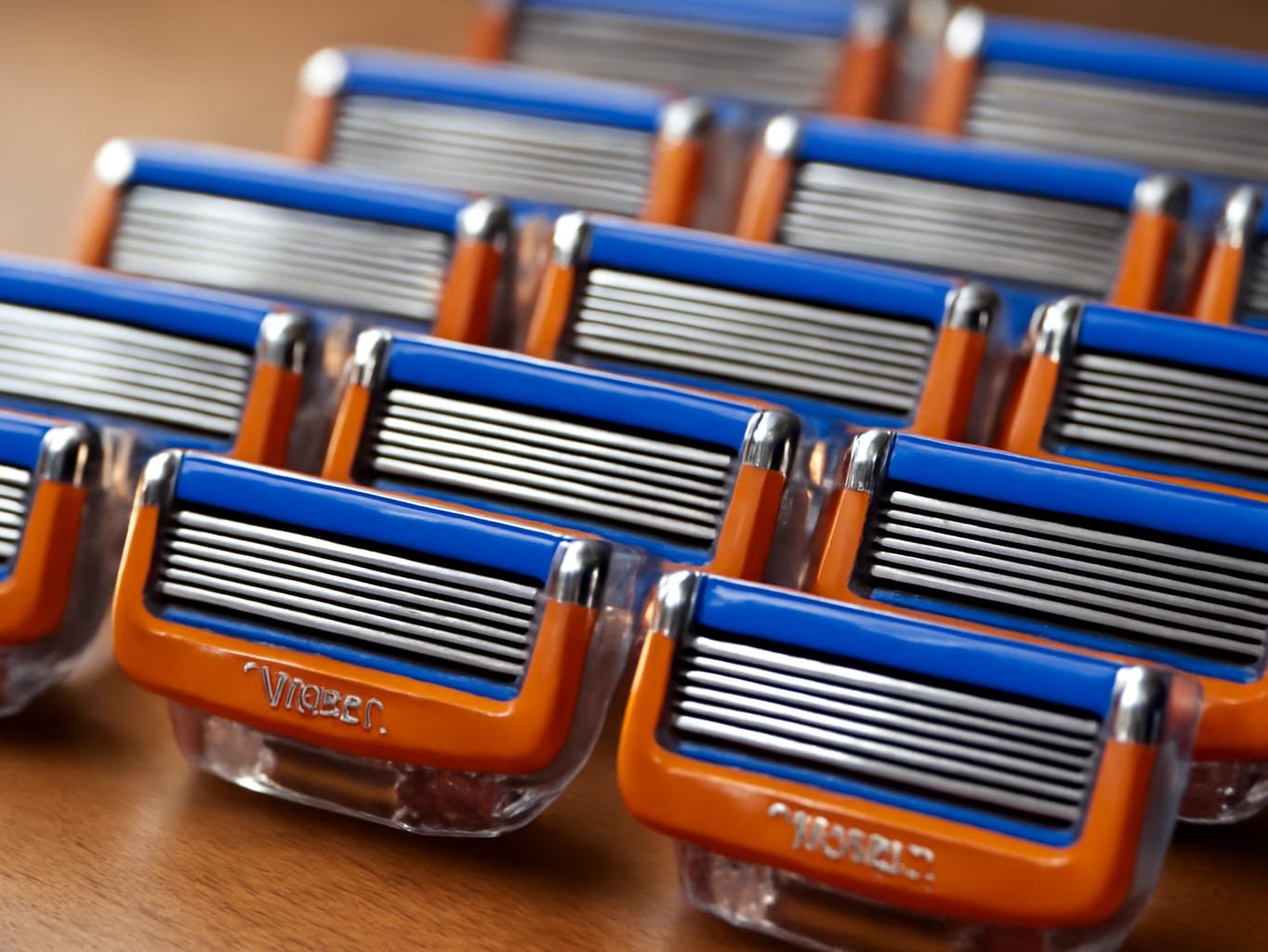 Sixteen razor blade cartridges arranged in rows, macro close-up showing metal blade heads in sharp detail